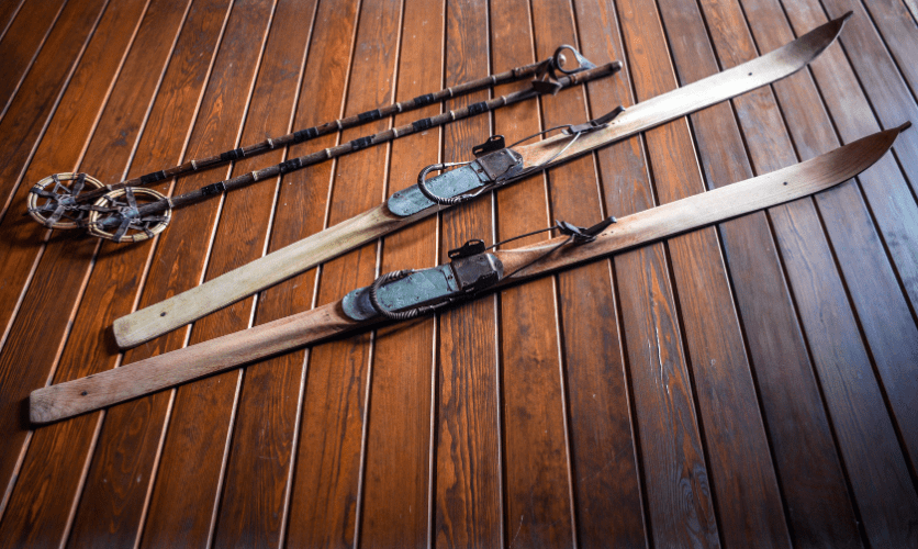 The history of Skis and Ski Poles, an image of old fashioned wooden skis and poles 