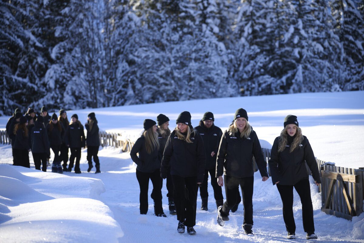 Ski Basics team walking through the snowy trees in Meribel, alongside friends made for life on their ski season