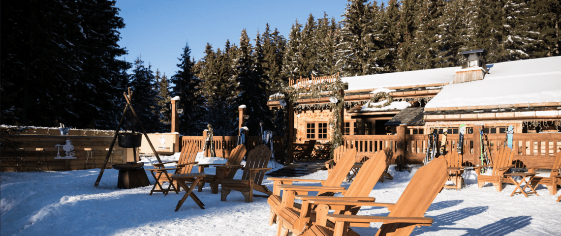 Wooden chairs in the sun on the snow